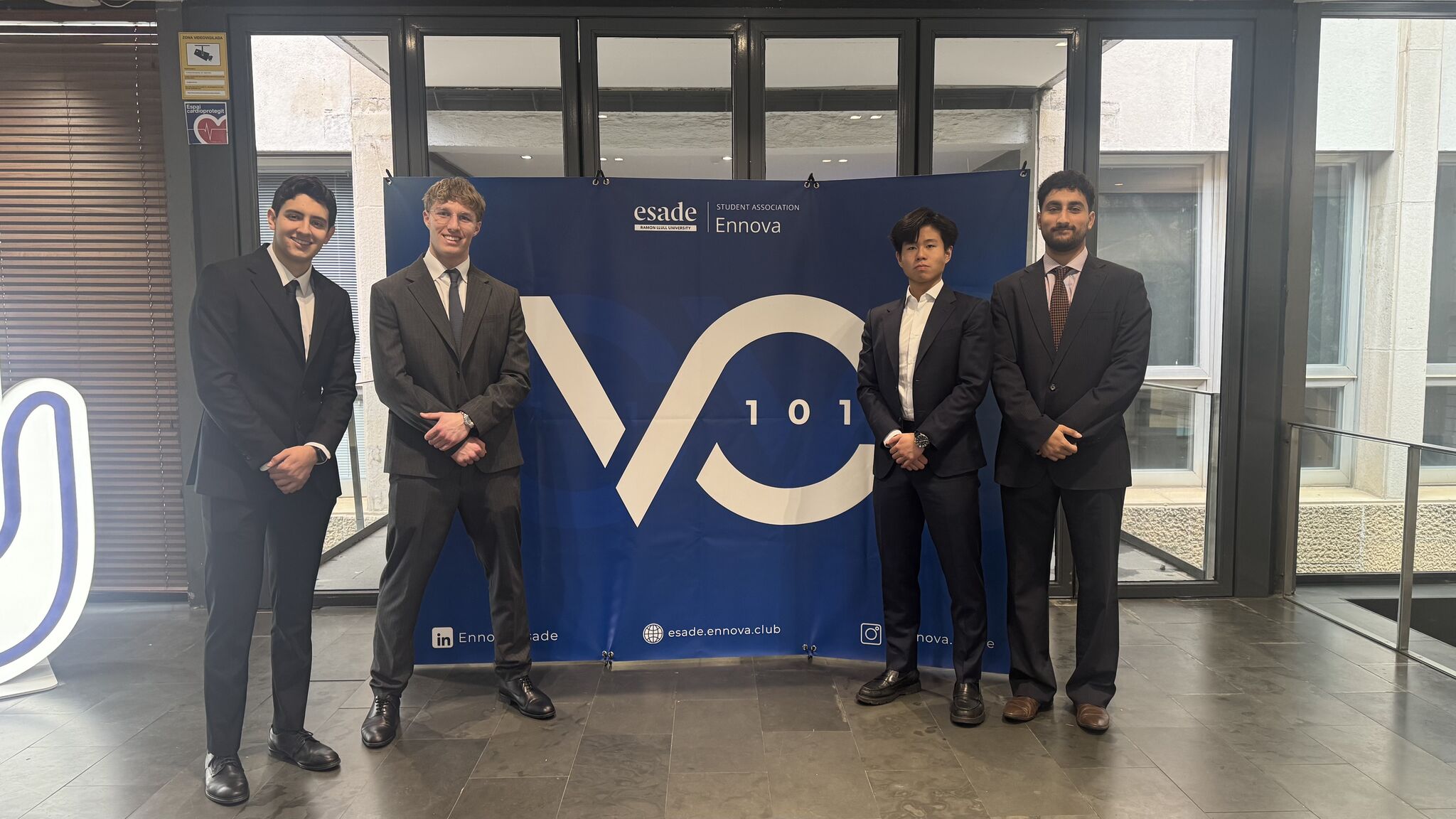Four VC101 participants in front of the Esade Ennova backdrop in Barcelona.